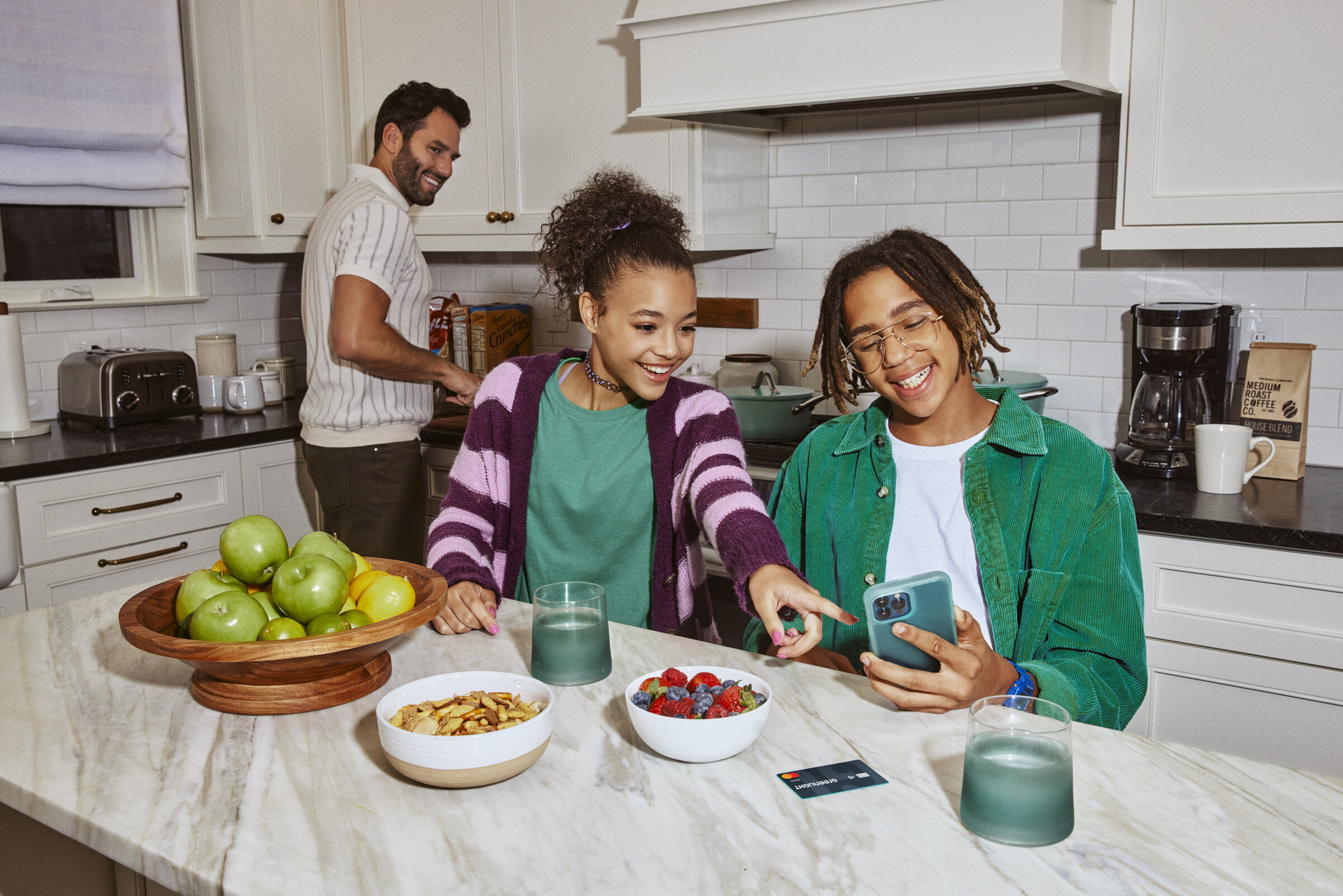 Kids using Greenlight together in a kitchen